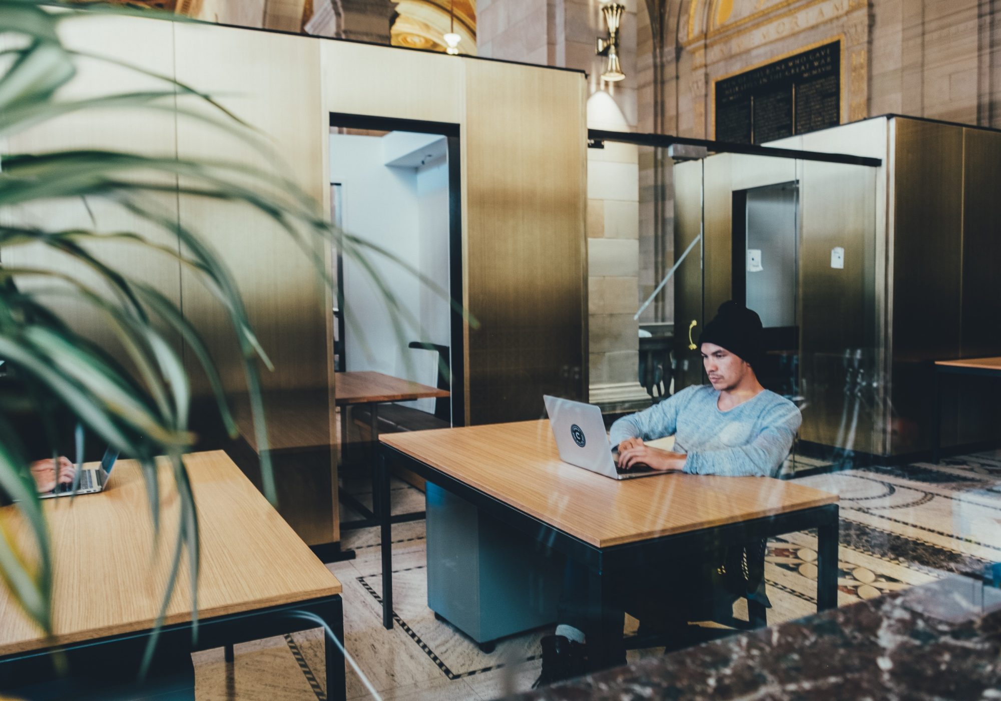Person working at a desk in an open office workspace